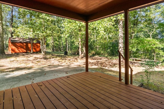 wooden terrace featuring a storage shed