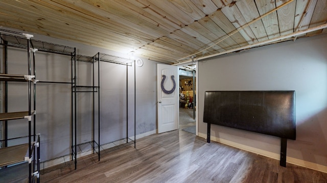 basement with hardwood / wood-style flooring and wooden ceiling