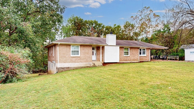 back of house featuring a lawn