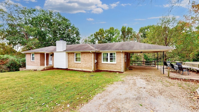 ranch-style home featuring a front yard and a carport