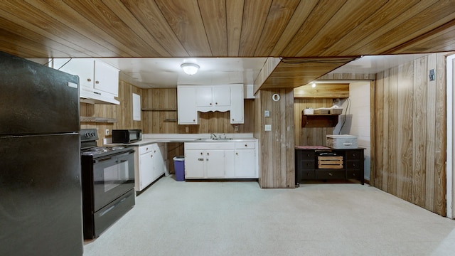 kitchen with wood ceiling, white cabinetry, black appliances, and wood walls