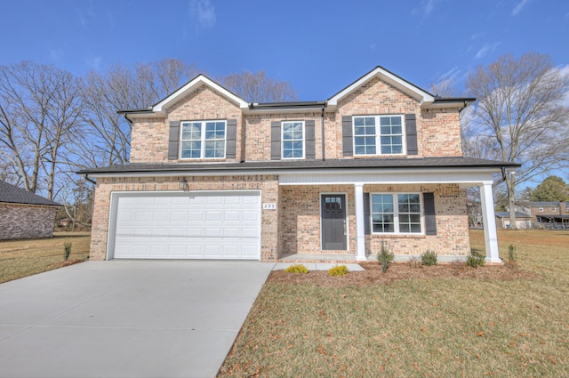 view of front of property with a garage and a front yard