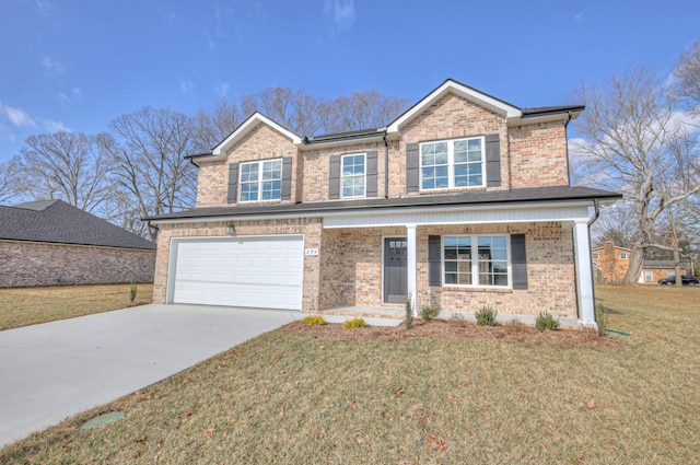 view of front of home featuring a garage, covered porch, and a front lawn