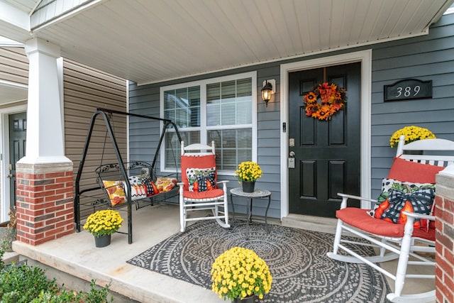 doorway to property featuring a porch