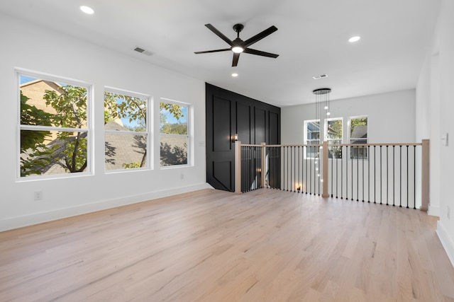 spare room with plenty of natural light and light wood-type flooring