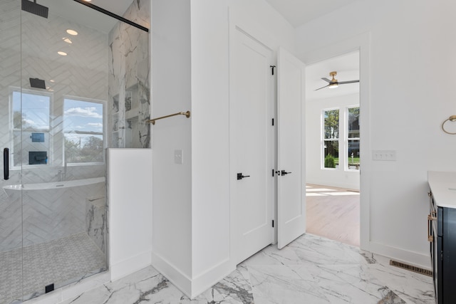 bathroom featuring vanity, ceiling fan, and an enclosed shower