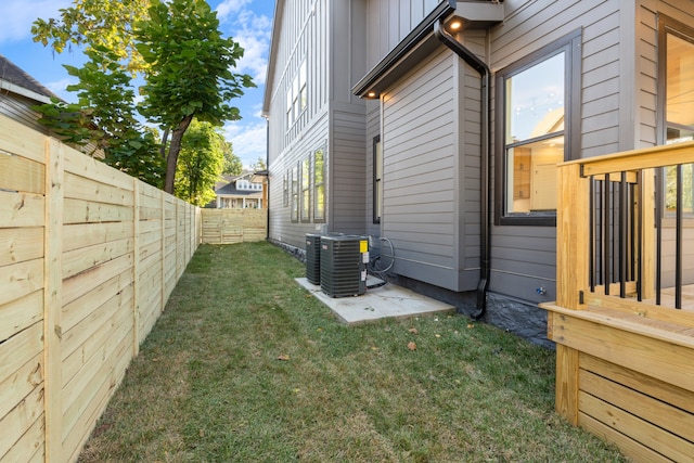 view of home's exterior with a yard and central air condition unit