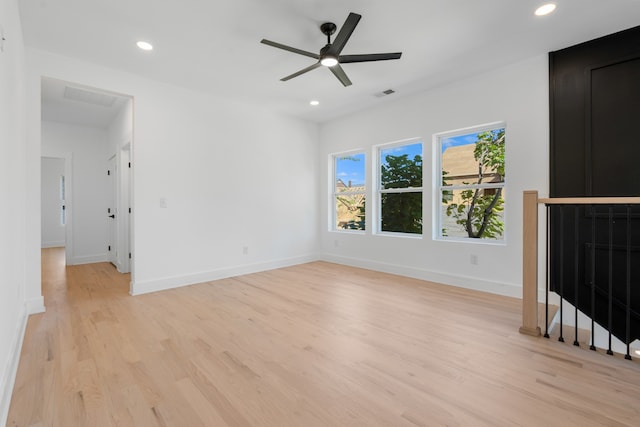 unfurnished living room with ceiling fan and light wood-type flooring