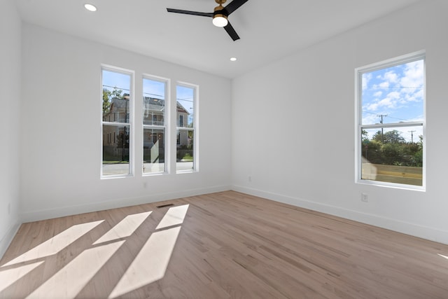 unfurnished room with light wood-type flooring and ceiling fan