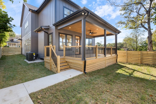 back of property with ceiling fan, a lawn, and cooling unit