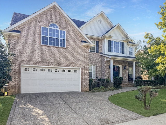 view of front of house featuring a front yard and a garage