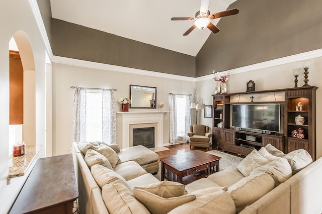 living room featuring crown molding, wood-type flooring, high vaulted ceiling, and ceiling fan