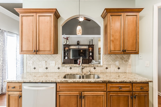 kitchen with dishwasher, decorative backsplash, ornamental molding, sink, and ceiling fan