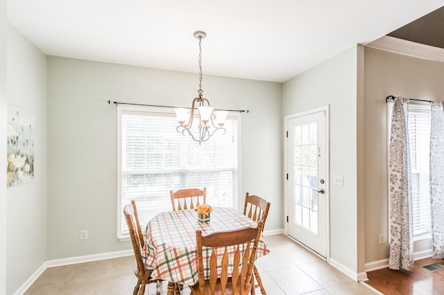 tiled dining area featuring an inviting chandelier