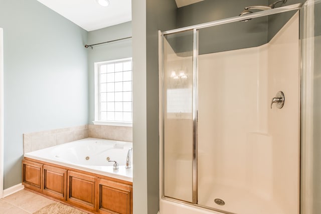 bathroom with shower with separate bathtub and tile patterned flooring