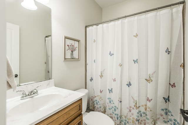 bathroom featuring vanity, toilet, and curtained shower