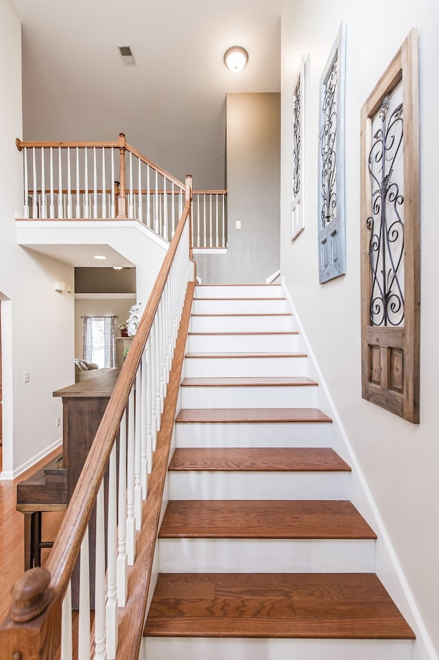 stairway with hardwood / wood-style floors