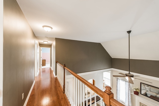 corridor featuring lofted ceiling and hardwood / wood-style flooring