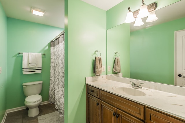 bathroom featuring vanity, toilet, and tile patterned flooring