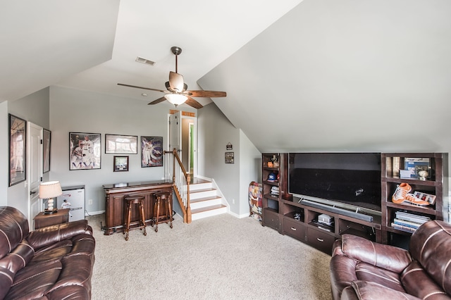 living room featuring ceiling fan, carpet flooring, and vaulted ceiling