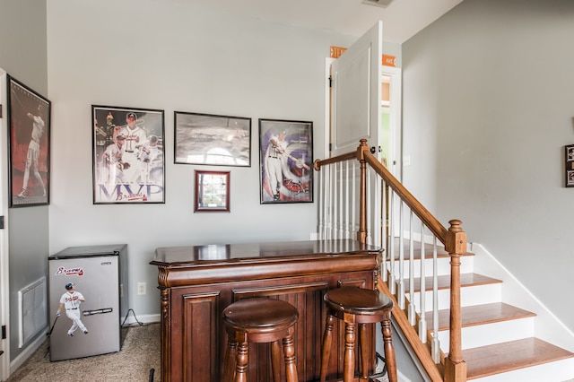 interior space with carpet and bar area