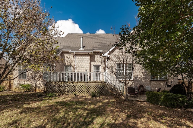 back of house featuring a yard and a wooden deck