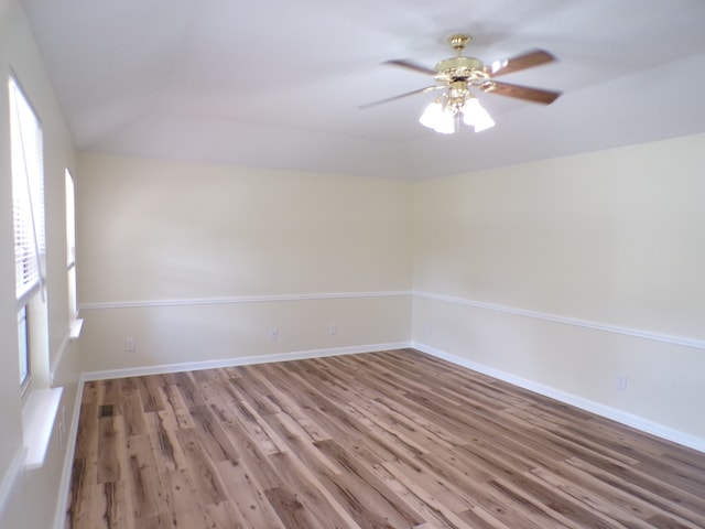 unfurnished room with ceiling fan, wood-type flooring, and vaulted ceiling