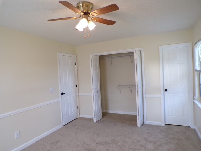 unfurnished bedroom featuring ceiling fan and light colored carpet