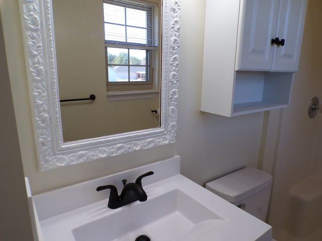 bathroom featuring toilet and sink