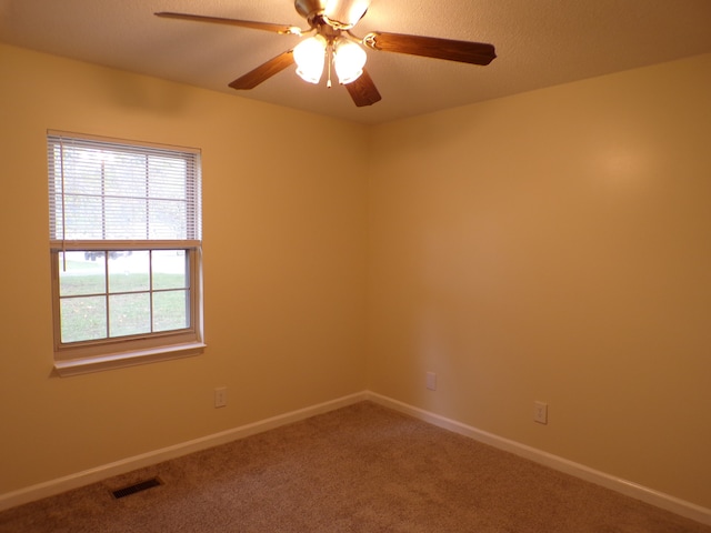 unfurnished room with ceiling fan and carpet flooring