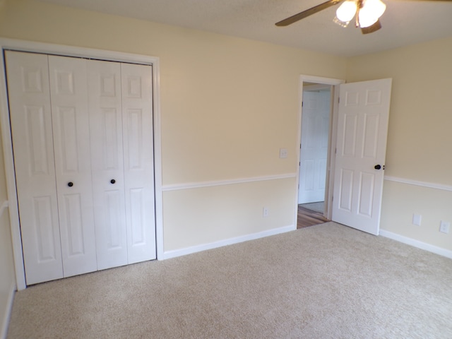 unfurnished bedroom featuring a closet, ceiling fan, and carpet