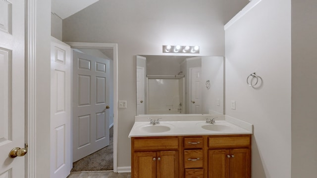 bathroom with a shower with door and vanity