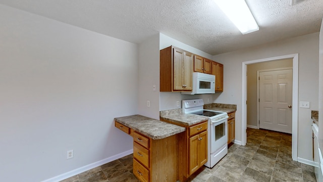 kitchen with white appliances and a textured ceiling