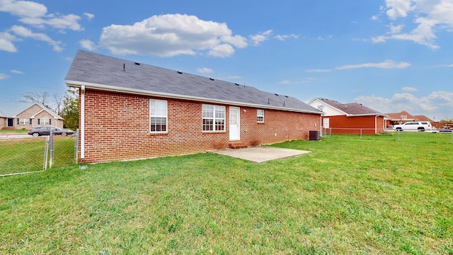 back of house featuring a patio area and a yard