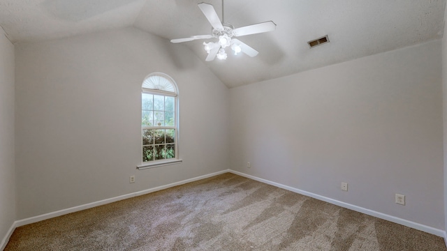 carpeted empty room with ceiling fan and vaulted ceiling