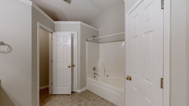 bathroom featuring  shower combination and vaulted ceiling