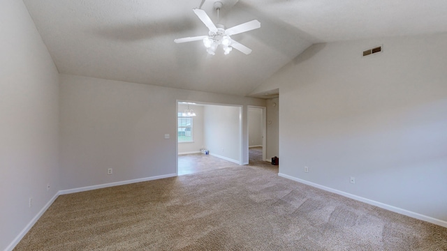 empty room with light colored carpet, ceiling fan, and lofted ceiling