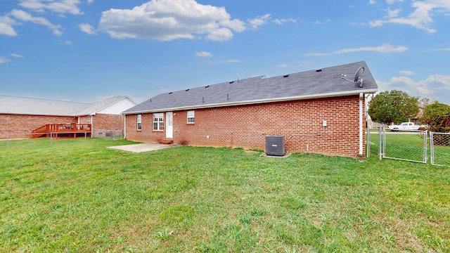 back of house featuring a patio area, a yard, and central air condition unit