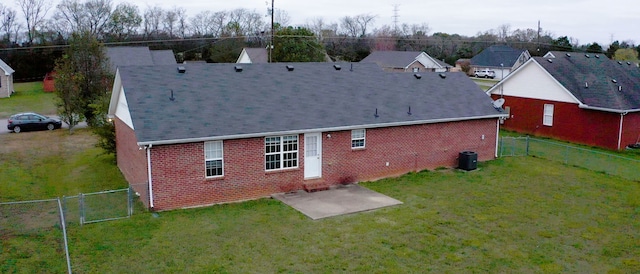 rear view of house with a lawn and a patio