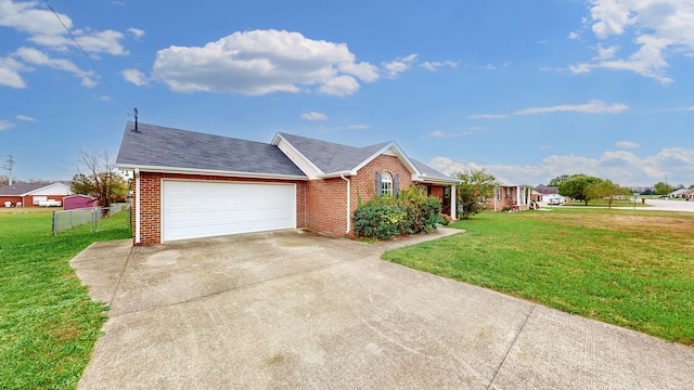 ranch-style home with a front lawn and a garage