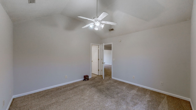 carpeted spare room with ceiling fan and lofted ceiling