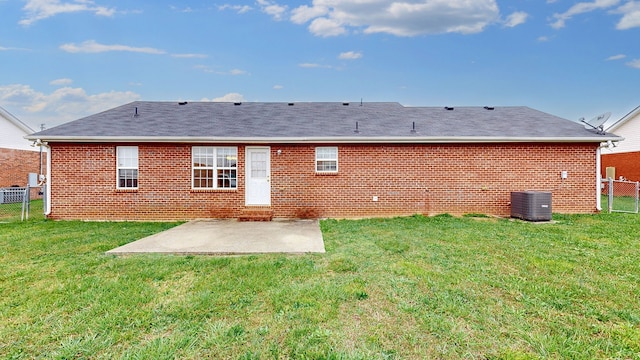 rear view of property featuring a patio, central AC unit, and a lawn