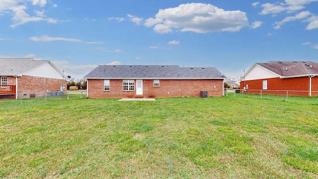 rear view of property with central air condition unit, a yard, and a patio