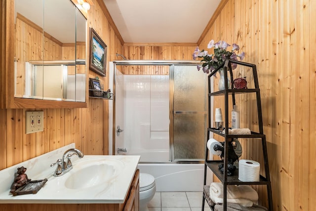 full bathroom with shower / bath combination with glass door, toilet, wooden walls, vanity, and ornamental molding