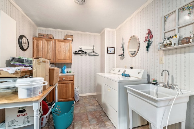 laundry room with cabinets, ornamental molding, sink, and washer and clothes dryer