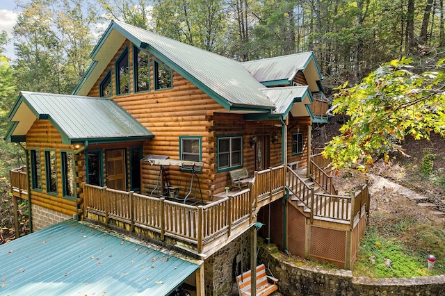 rear view of property with a wooden deck