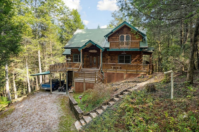 log cabin featuring covered porch