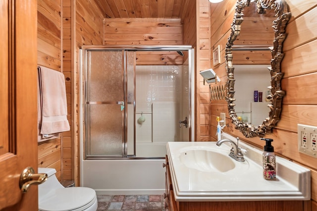 full bathroom with combined bath / shower with glass door, wooden ceiling, toilet, wood walls, and vanity