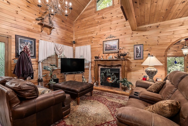 living room featuring a premium fireplace, wood ceiling, high vaulted ceiling, and wooden walls