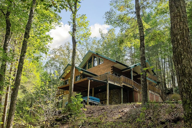 rear view of house featuring a deck